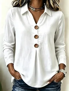 Detailed view of white long-sleeved shirt with decorative wood buttons and pleated texture