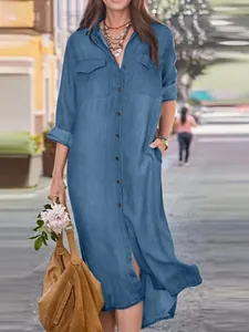 Full length denim shirt dress with collar and button front in a casual street style.