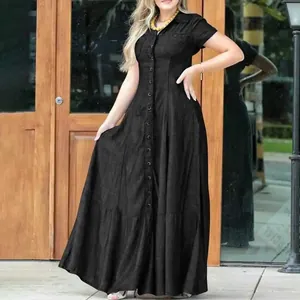 Detailed view of a black denim maxi dress featuring a shirt collar and front buttons