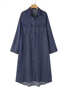 Front view of long-sleeved denim shirt dress with pockets and curved hem detail.