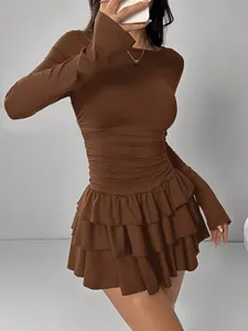 Detailed view of a slim fit brown long-sleeved mini dress with ruffled tiered skirt.
