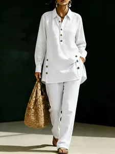 Full view of a women's white long-sleeve linen shirt and matching casual trousers.