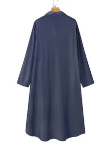 Rear view of a casual dark blue denim long dress with a shirt collar and long sleeves.