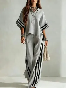 Detail view of a grey casual women's two-piece set featuring a shirt and striped pants