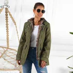 Detailed view of a women's olive green parka featuring lush faux fur lining and hood