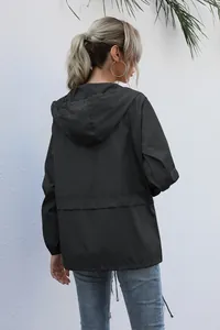 Detailed back view of a lightweight black hooded rain jacket for women outdoor hiking