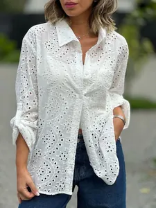 Detailed view of white hollow-out embroidered cotton button-down shirt for women