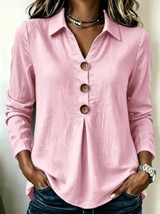 Detail view of a pink long-sleeved blouse featuring a V-neck, collar and brown buttons