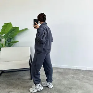 Full body side view of a women's grey oversized fleece hoodie and jogger tracksuit set