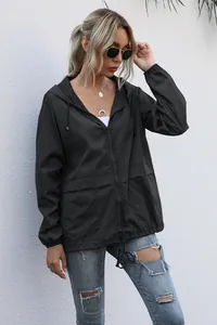 Detailed view of women's black lightweight hooded windbreaker for outdoor hiking.