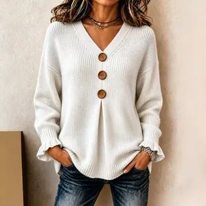 Elegant white V-neck knit sweater featuring decorative buttons and feminine ruffled cuffs