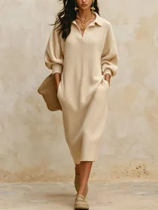Detail of beige V-neck ribbed knit maxi dress with pockets and buttons