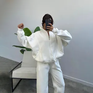 Full view of women's white oversized fleece tracksuit with zip-up hoodie and joggers