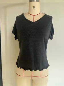 Close-up of a charcoal grey V-neck short sleeve T-shirt with ruffled hem and sleeve detail