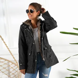 Stylish women's black mid-length parka featuring a cozy faux fur hood and zip closure