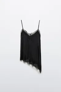 Detailed view of black asymmetrical lace camisole with delicate floral embroidery.