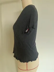 Detailed side view of a grey V-neck t-shirt featuring lettuce edge sleeves and hem.