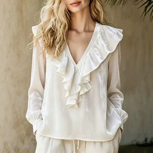 Elegant white velvet V-neck blouse featuring feminine ruffle trim and a soft lustrous finish