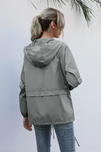 Back view of a lightweight grey waterproof hooded jacket for outdoor hiking and casual wear