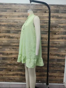 Side view detail of a light green sleeveless stand-collar dress with elegant ruffle hemline