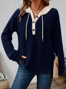 Close-up of navy blue ribbed hoodie with buttoned V-neck and cream drawstring hood