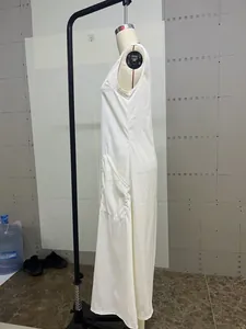 Minimalist elegant white sleeveless maxi dress with side pocket on mannequin profile.