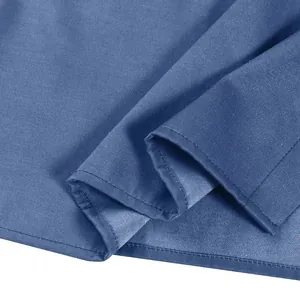 Macro view of blue denim fabric showing refined stitching and high-quality texture