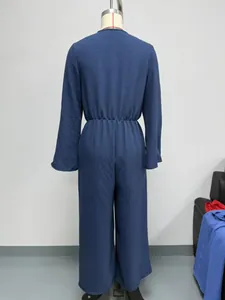 Detailed back view of a long sleeve bohemian jumpsuit with elastic waist in navy blue