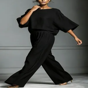 Elegant black linen two-piece set featuring stylish bell sleeves and wide-leg trousers