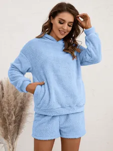 Close-up showing the soft texture of a light blue fuzzy hoodie and shorts lounge set