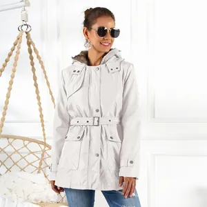 Full view of white women's winter parka with fur hood on model in lifestyle setting