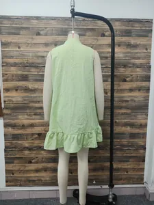 Back view of light green sleeveless stand collar dress with ruffle hem detail.