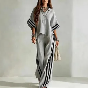 Casual women's two-piece set with grey short-sleeve shirt and wide-leg striped pants.