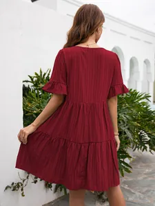 Back view of women's wine red tiered casual dress featuring ruffle sleeves and a loose fit