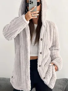 Close-up of a cozy grey fuzzy hooded jacket worn by a model in a mirror selfie