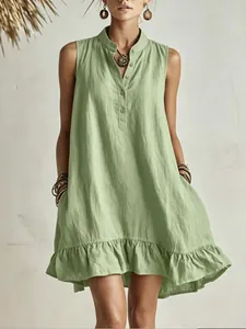 Detailed view of a sage green sleeveless dress with mandarin collar and ruffled hem