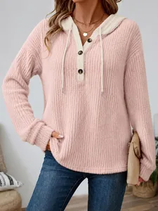 Close-up of pink ribbed hooded top with cream drawstring and button neckline detail