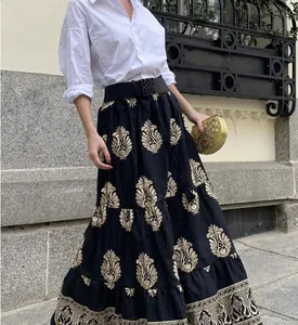 Bohemian high-waist black A-line maxi skirt with gold ornamental floral patterns