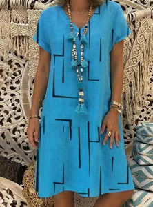 Detail view of women's bohemian blue V-neck dress with black geometric line print