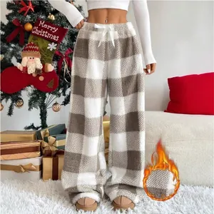 Detail showing the warm fleece texture and brown plaid pattern of these wide-leg lounge pants.