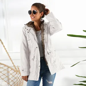 Detailed view of women's white mid-length parka featuring a plush faux fur-trimmed hood.
