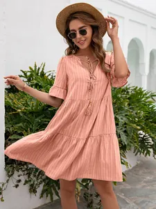 Bohemian peach V-neck tiered summer dress with ruffle sleeves and tassel drawstring detail