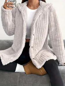 Close-up of cozy light gray hooded fuzzy jacket with soft plush texture for winter
