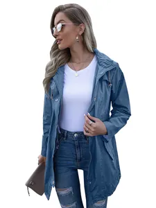 Detail shot of a stylish women's blue hooded zip-up raincoat with drawstring and zip