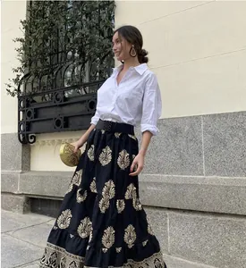 Elegant bohemian high waist A-line long skirt with intricate gold floral embroidery details