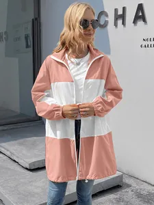 Detail view of pink and white hooded color-block waterproof windbreaker jacket.