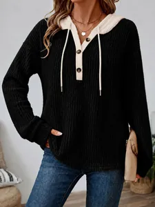 Close-up of casual black and beige knitted hoodie with button V-neck and drawstrings.