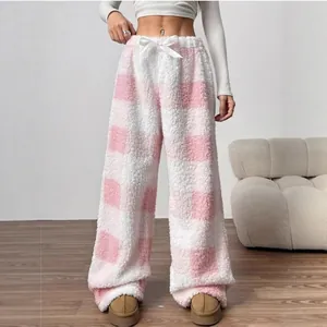 Detailed view of women's cozy pink and white checkered sherpa wide-leg lounge pants