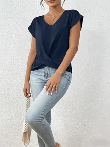 Detail of navy blue V-neck short sleeve blouse with elegant twist front hem