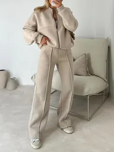 Women's stylish beige two-piece loungewear set featuring zip-up hoodie and wide-leg pants